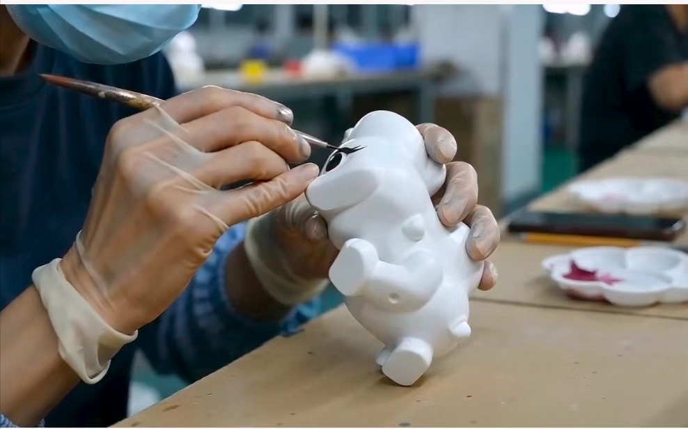 Royalwell Crafts artisan hand painting a resin craft